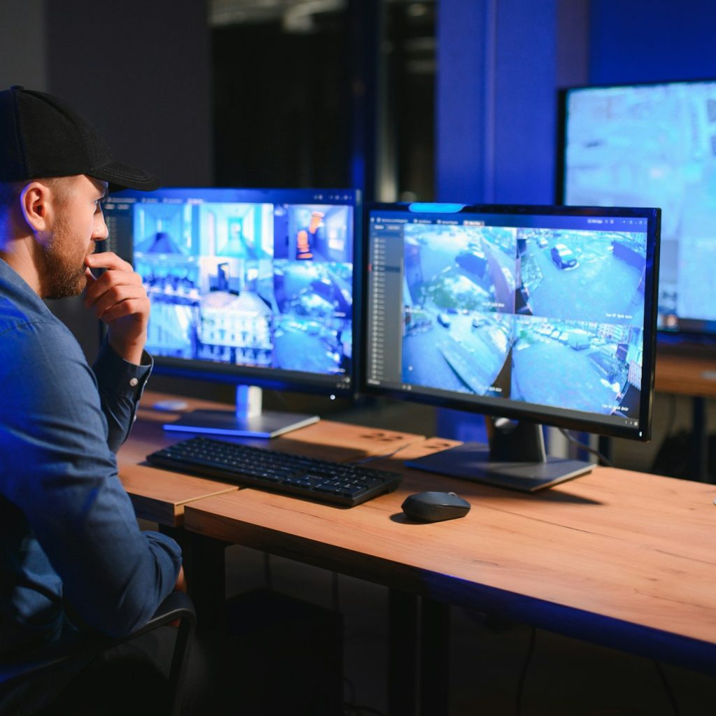 Alarm Monitoring 3 Male security guard monitoring modern CCTV cameras indoors